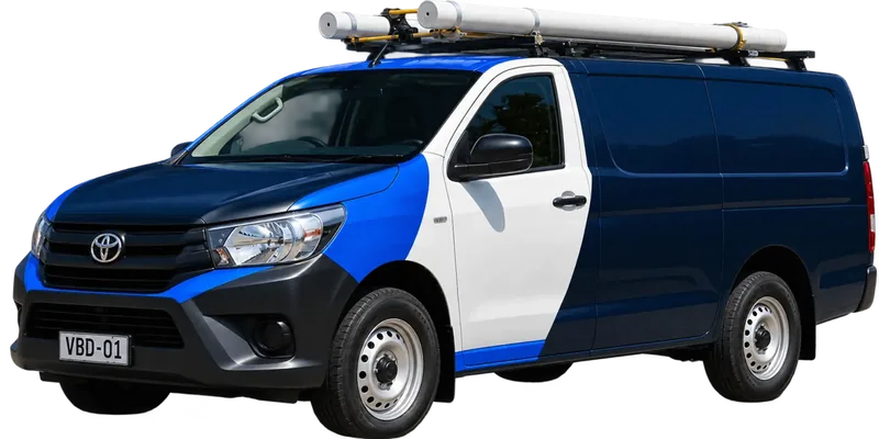 A licensed Bondi plumbing van loaded with pipe on the roof rack